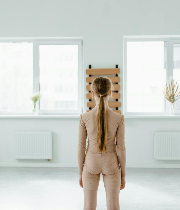 Person practicing gentle movement in a calm room