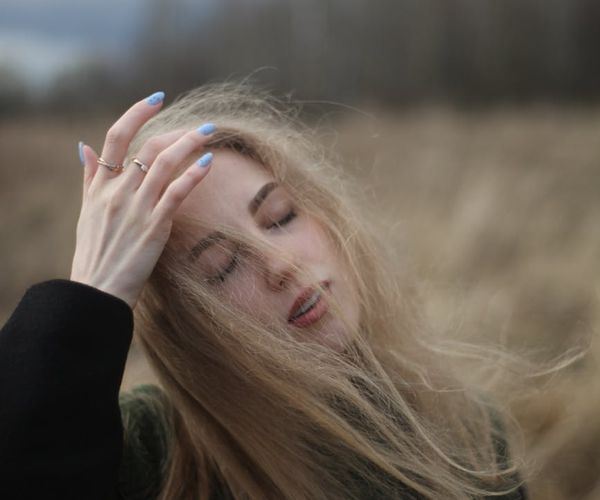 Person stretching gently near a sunlit window